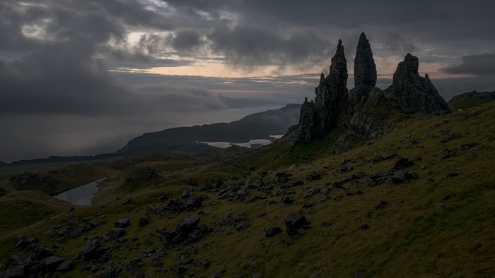 Dramatic rock formations at sunrise over a misty landscape
