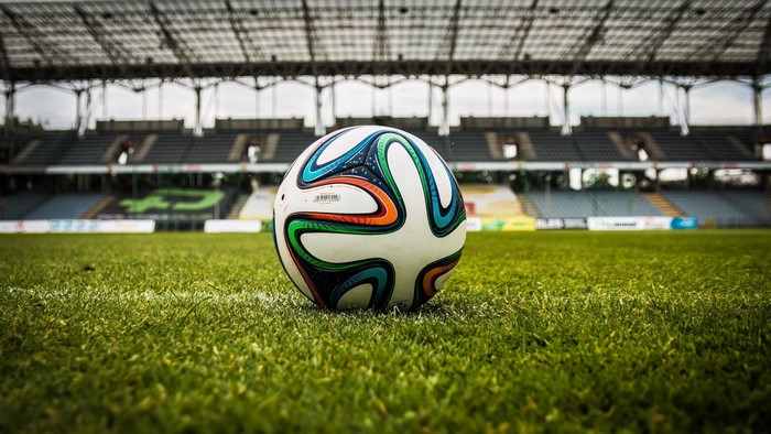 Soccer ball on a grassy field in a stadium
