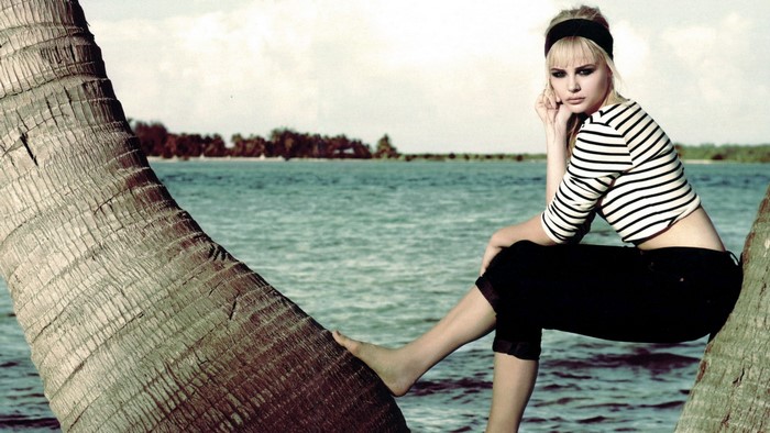 Chloe Moretz on a palm tree by the ocean