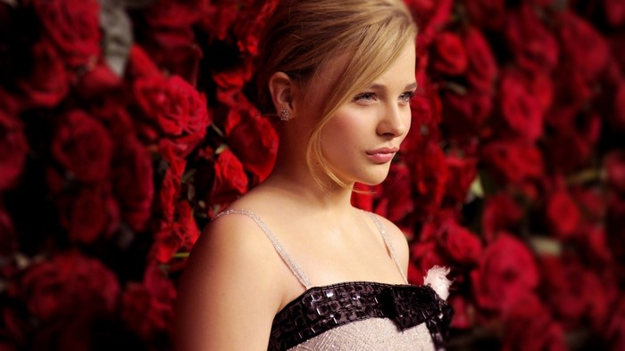 Chloe Moretz in front of red roses