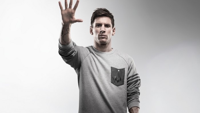 Lionel Messi wearing a grey sweatshirt