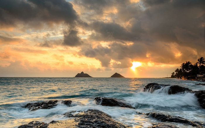 Sunrise over the ocean with islands and rocks