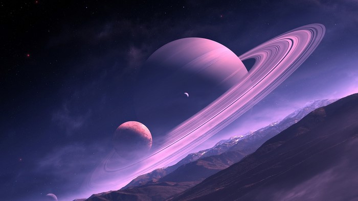Saturn and moons over alien mountains