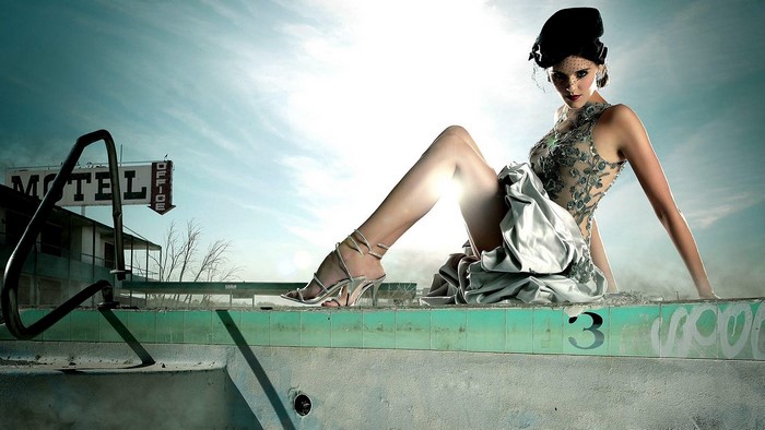 Maggie Grace posing by a motel pool