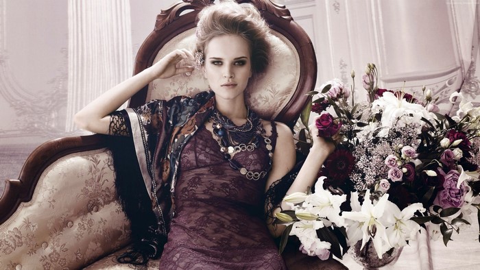 Iza Olak fashion model in ornate chair with flowers