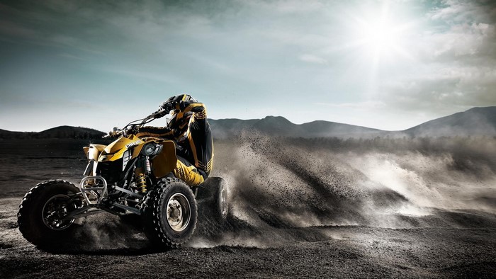 Yellow ATV Rider Kicking Up Dust