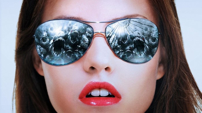 Woman wearing sunglasses reflecting sharks