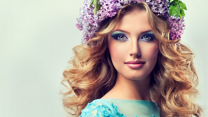 Woman with blonde curly hair and flower crown