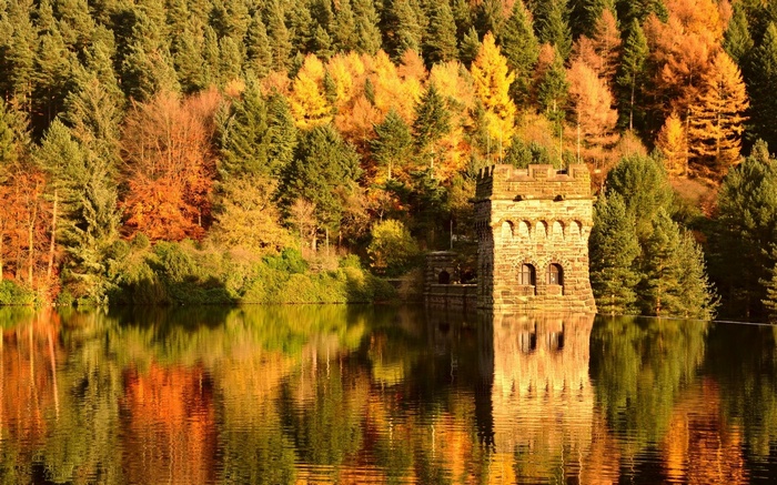 Stone tower in a lake with autumn trees
