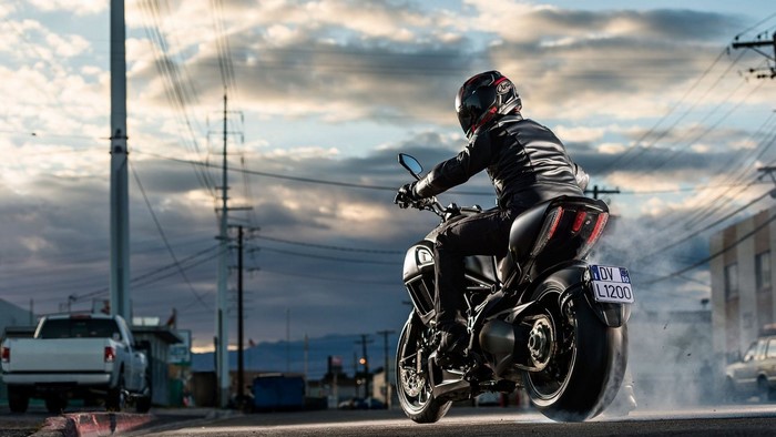 Ducati Diavel motorcycle with rider on street