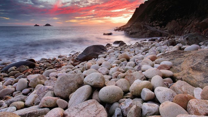 Rocky beach at sunset with colorful sky