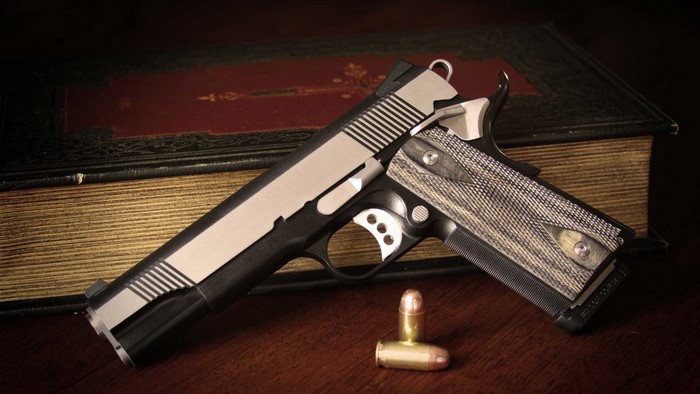 Close-up of a 1911 pistol with bullets