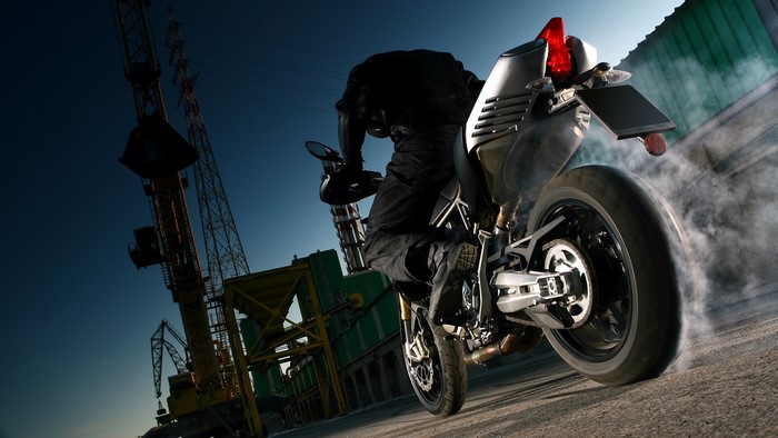 Aprilia Dorsoduro motorcycle doing a burnout