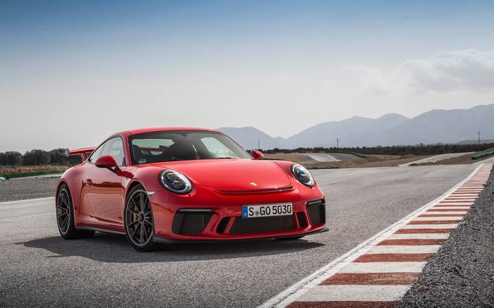Guards Red Porsche 911 GT3 on a Racetrack