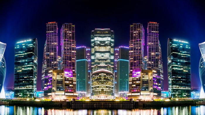 Moscow skyscrapers at night reflected in water