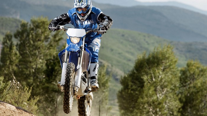 Yamaha dirt bike rider in blue gear on a trail