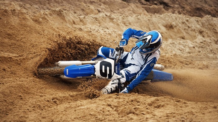 Yamaha dirt bike rider on sandy track
