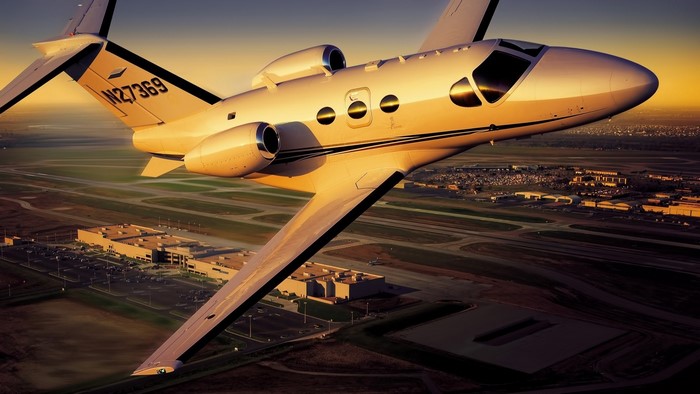 Private jet N27369 flying over an airport