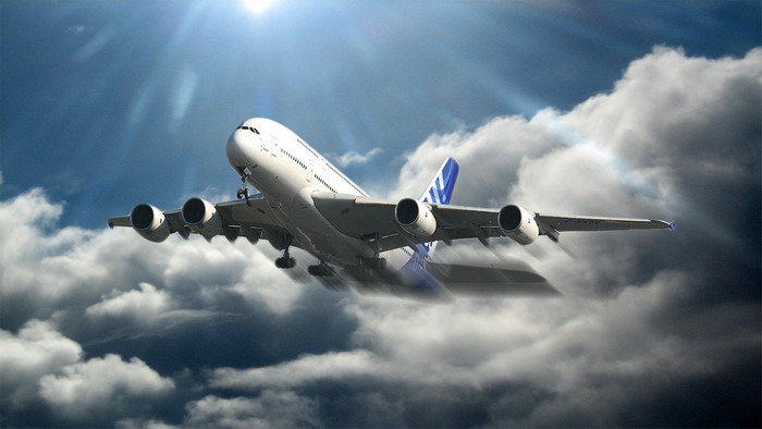 Airbus A380 airplane flying through clouds