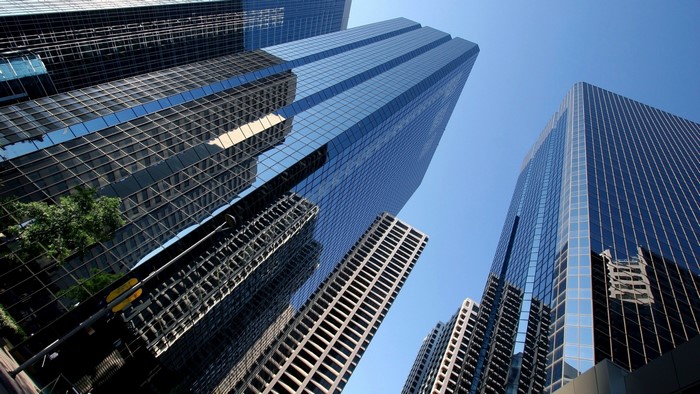 Skyscraper glass buildings against a clear blue sky