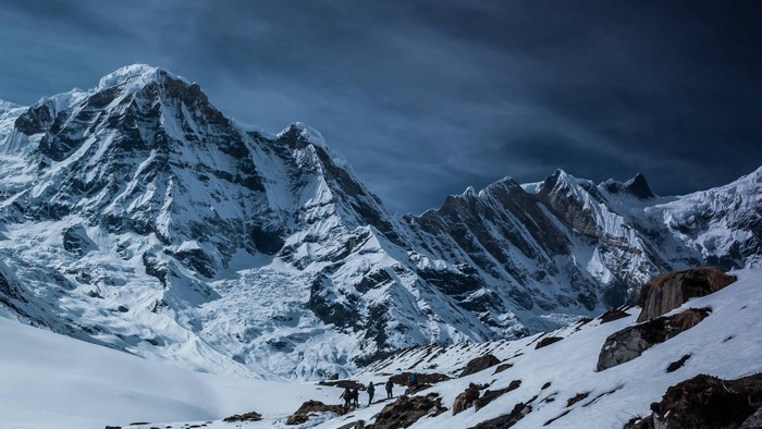 Hikers on a snowy mountain trail