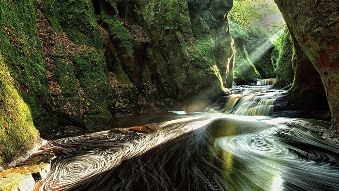 Mossy gorge with a river and waterfalls