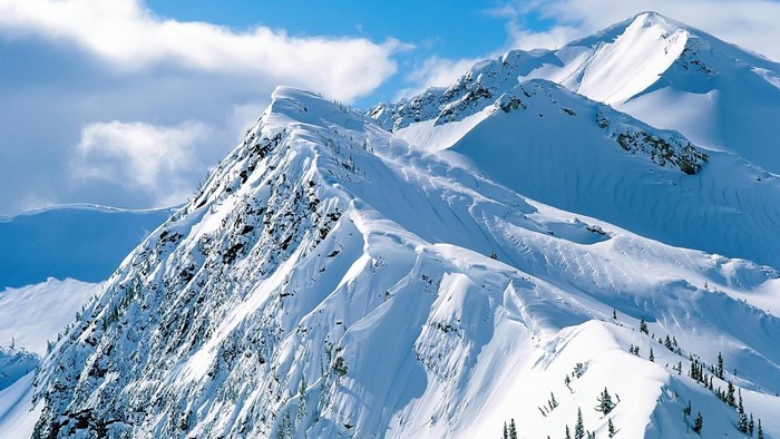 Snowy mountain range under a blue sky
