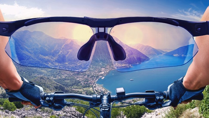 Person riding a bicycle with sunglasses showing mountain view