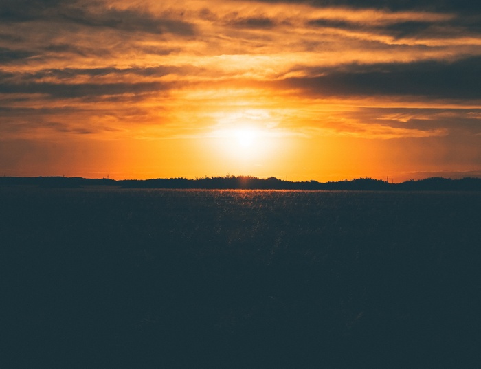 Sunset over a dark field