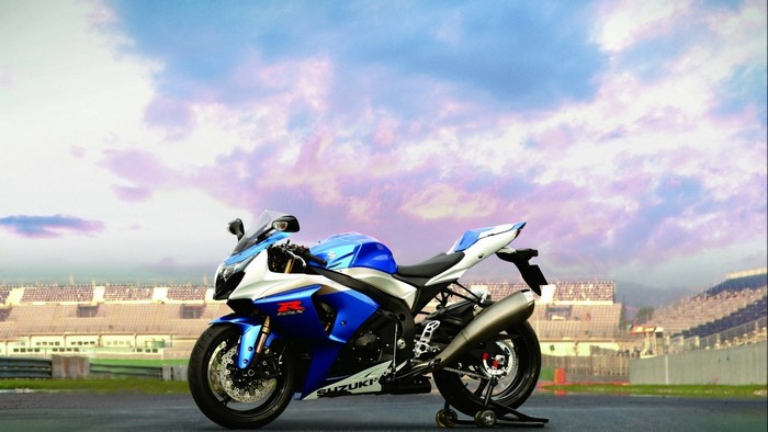 Blue and white Suzuki GSX-R1000 motorcycle on a racetrack