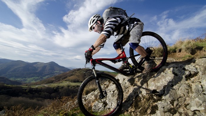 Mountain biker riding downhill on a rocky trail
