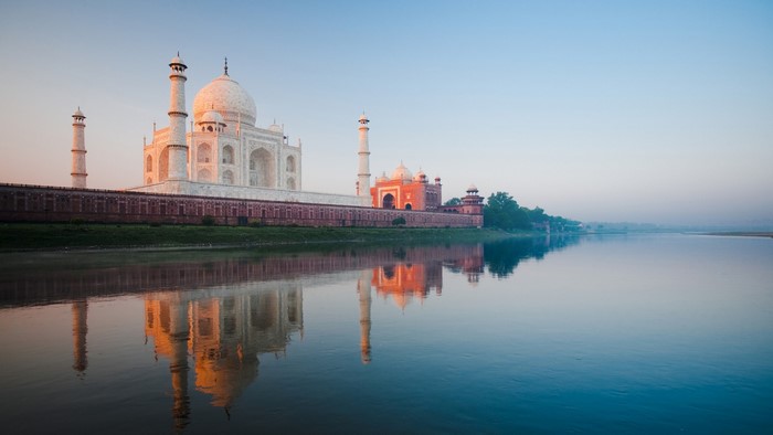 Taj Mahal reflected in the Yamuna River at sunrise