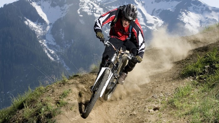 Mountain biker riding downhill on a dirt path