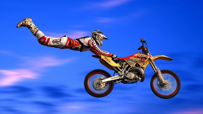 Motocross rider performing a stunt in the sky