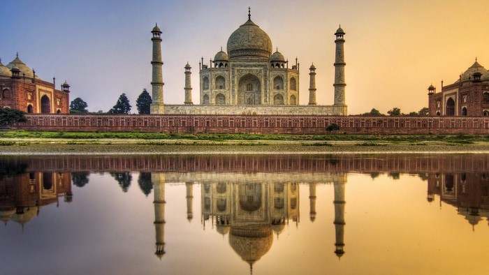 Taj Mahal reflected in water at sunrise