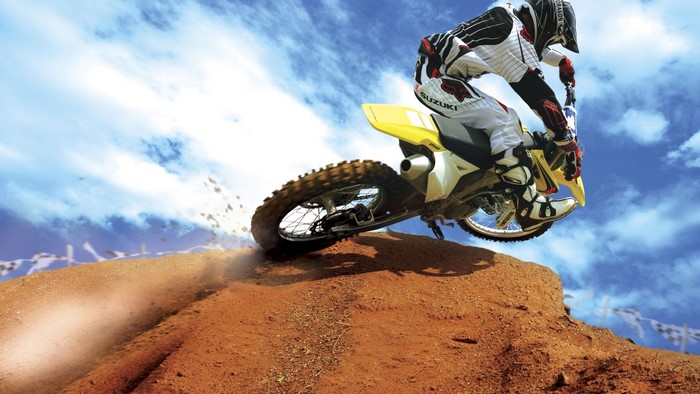 Motocross Rider on Suzuki Bike Jumping Dirt Ramp