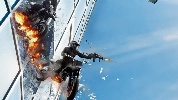 Motorcyclists on a burning motorcycle stunt