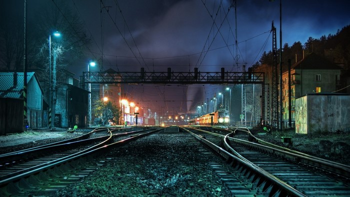 Train tracks at a station at night