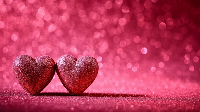 Two Glittery Hearts on a Pink Bokeh Background