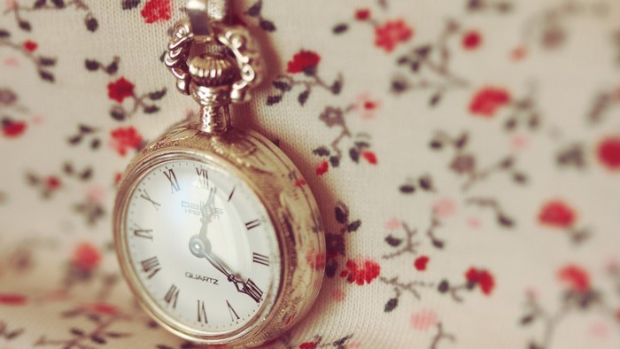 Vintage pocket watch on floral fabric