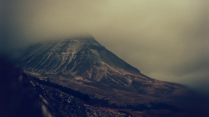 Mountain peak shrouded in fog