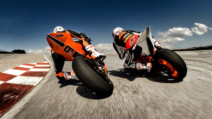 Two KTM 1190 RC8 R motorcycles racing on a track
