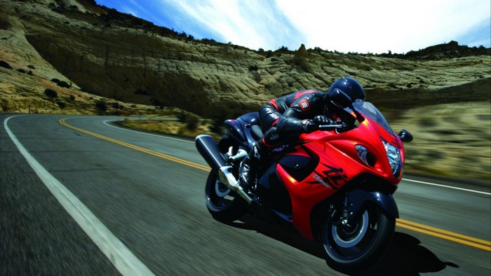 Red Suzuki Hayabusa motorcycle on a winding road