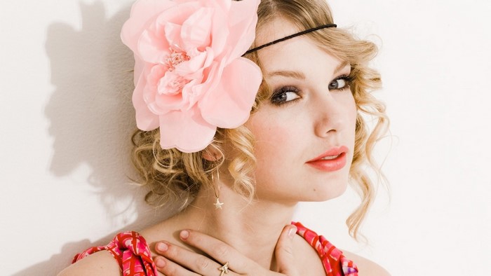 Taylor Swift with a pink flower