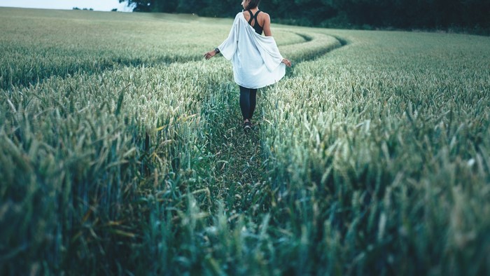 Woman walking through a wheat field