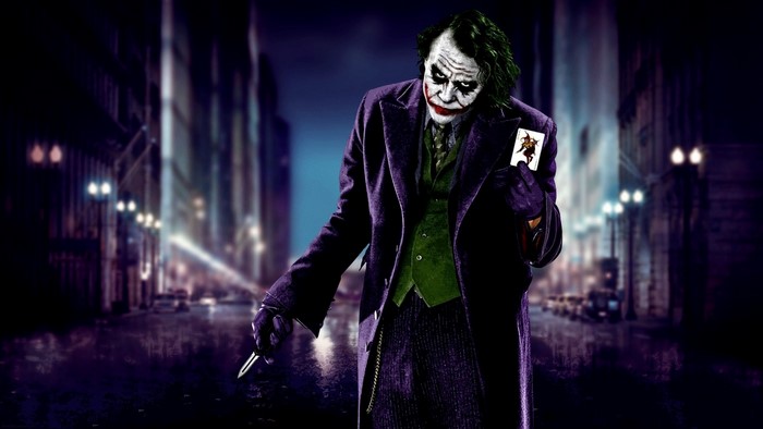 The Joker from Batman holding a playing card and a knife