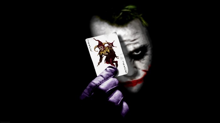 The Joker holding a Joker card