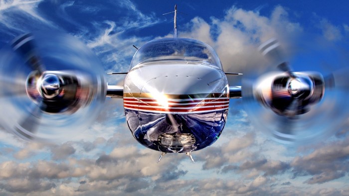 Vintage Twin-Engine Airplane in Flight