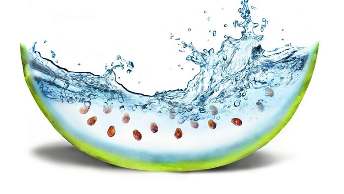 Watermelon slice with splashing water and seeds