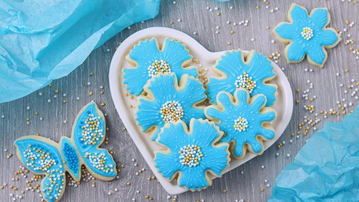 Blue flower and butterfly cookies with sprinkles